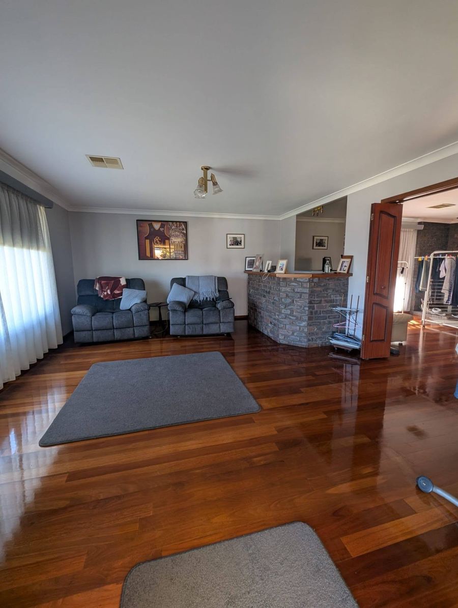 Living room in a Bunbury home after a full ZeroGrime Solutions clean, with polished timber floors and clear surfaces